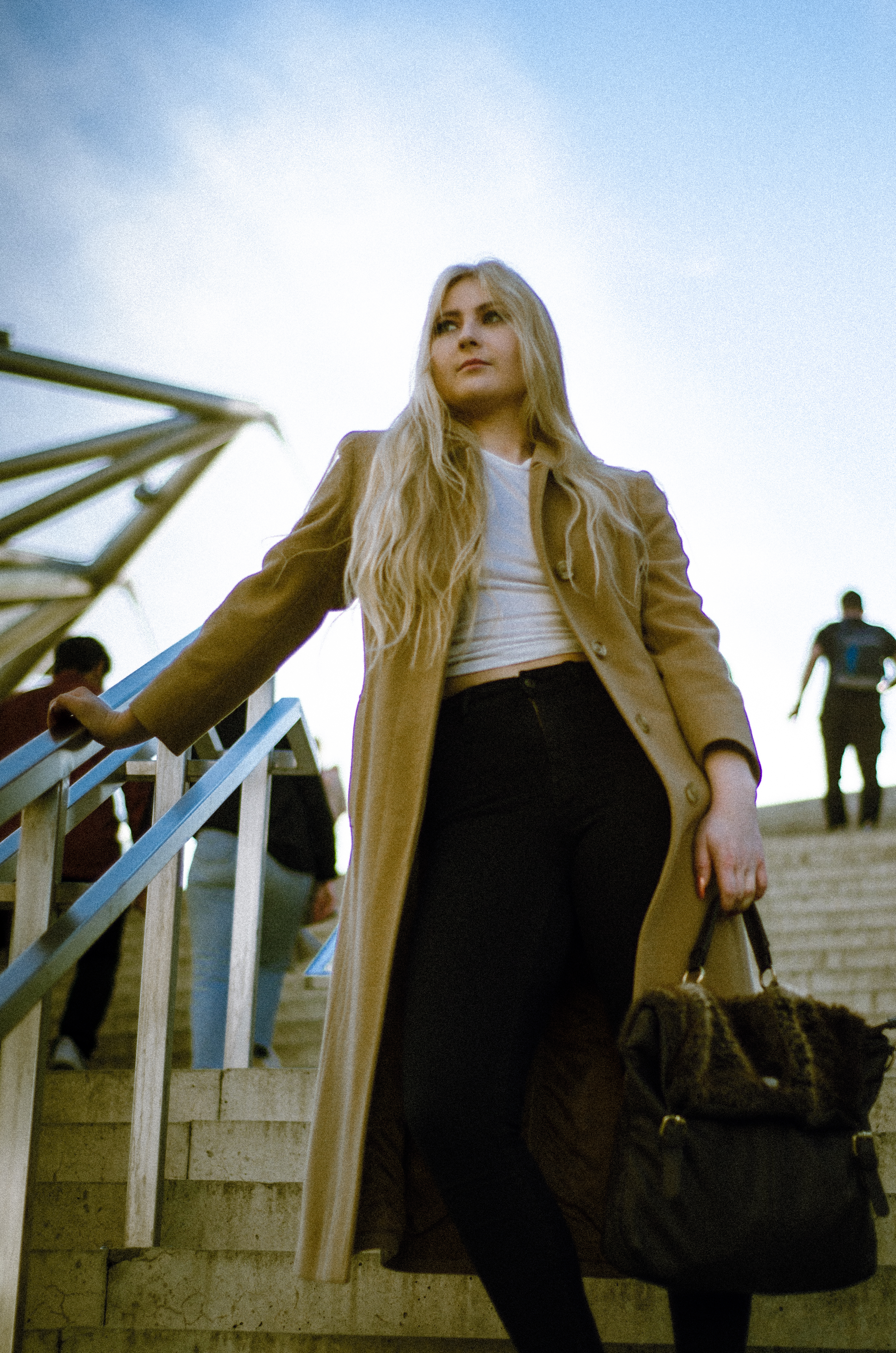 Woman in heels posing with a purse