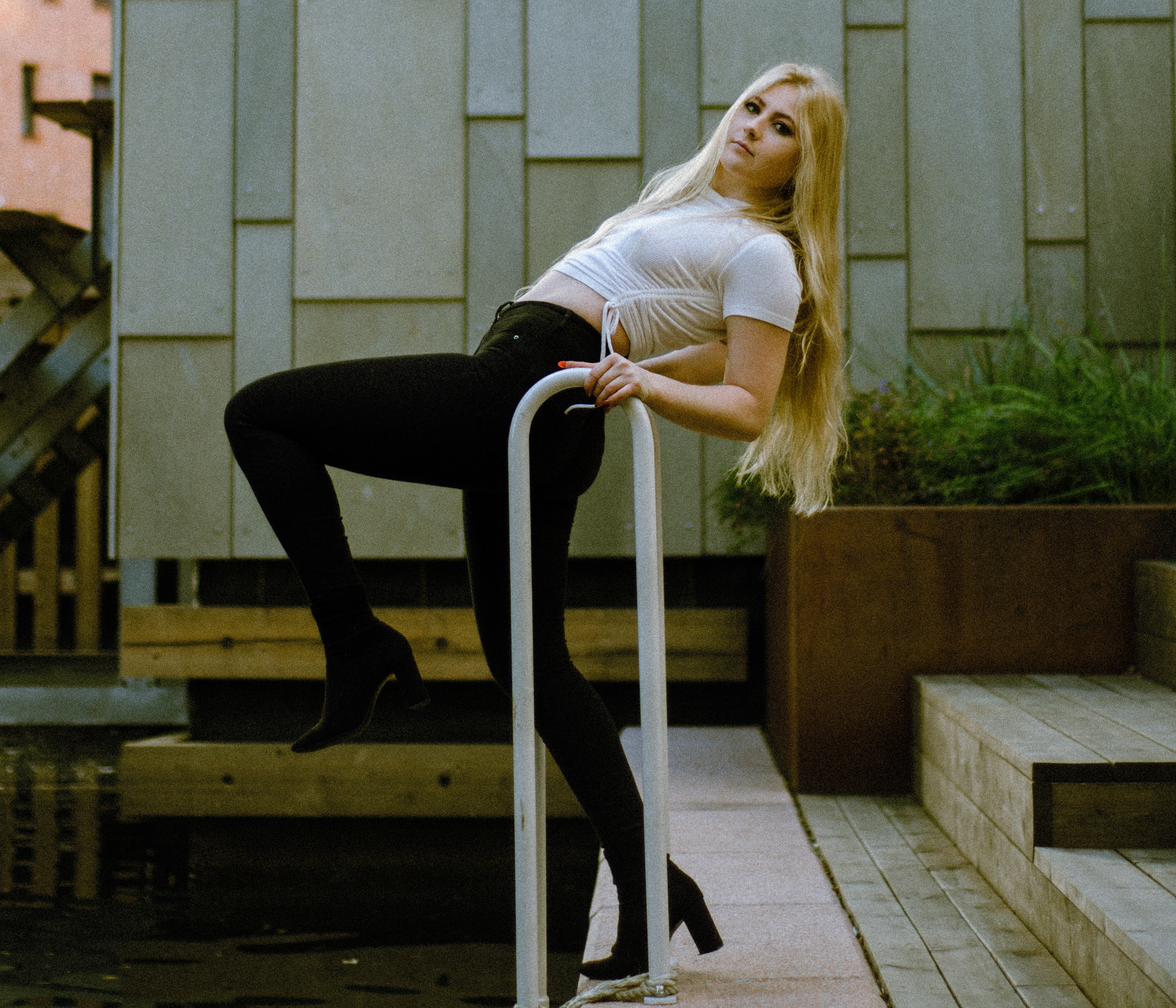 Woman in heels posing by the water