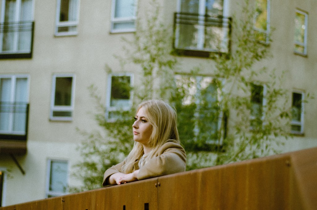 Woman at a bridge watching the horizon
