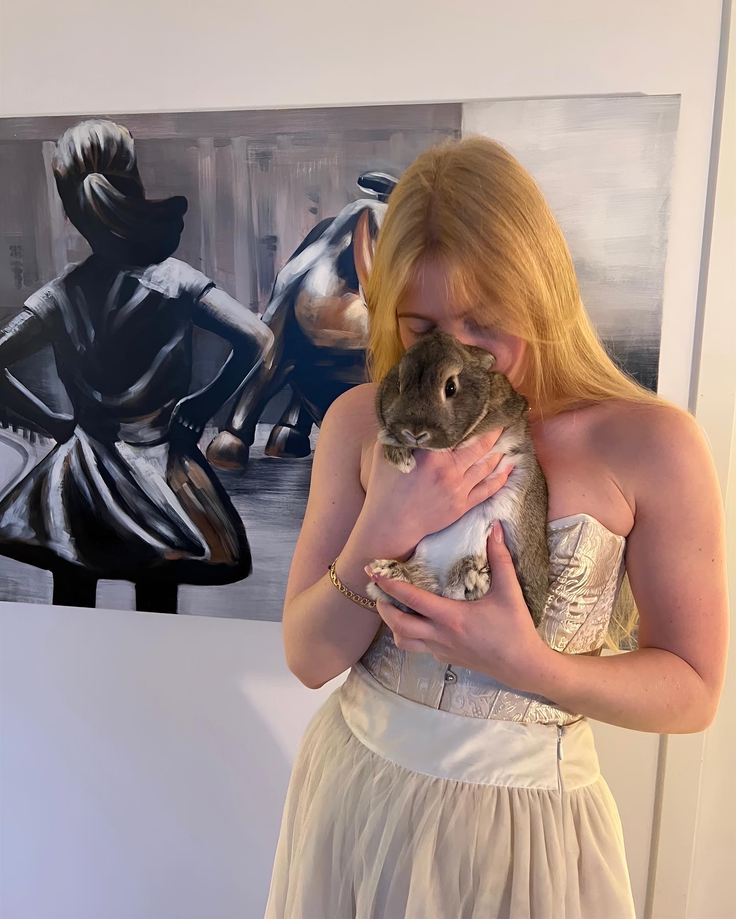 Woman in a corset and big skirt posing with her bunny