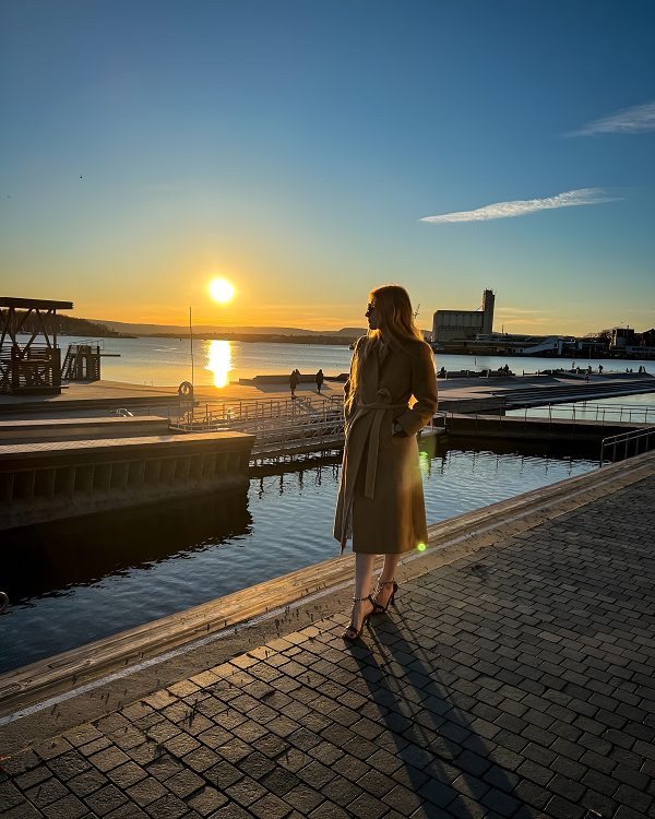 Lady in a coat and heels during sunset