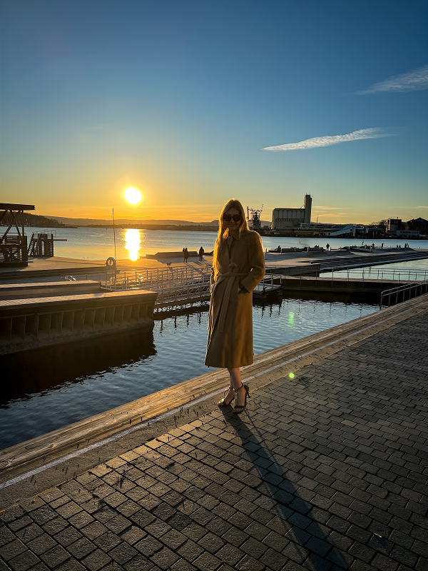 Woman by the sunset, harbour and sea