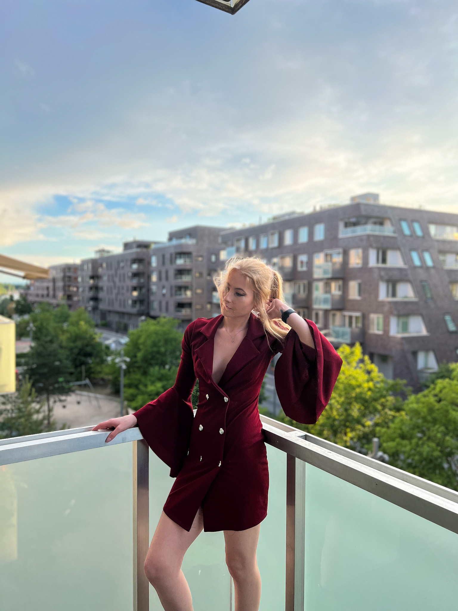 Red dress and horizon view where a woman stands watching the day be through