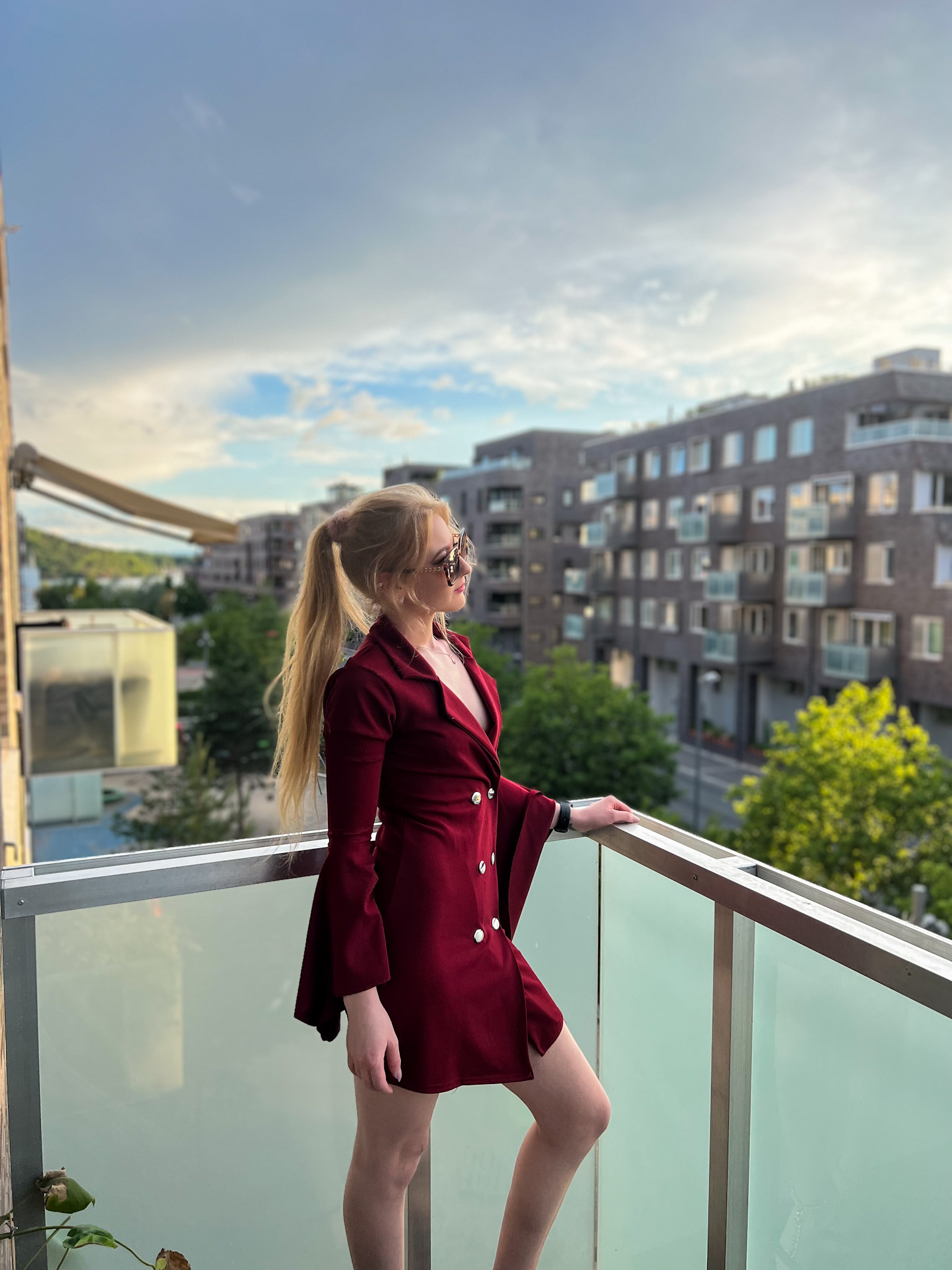 Red dress and horizon view where a woman stands watching the day be through