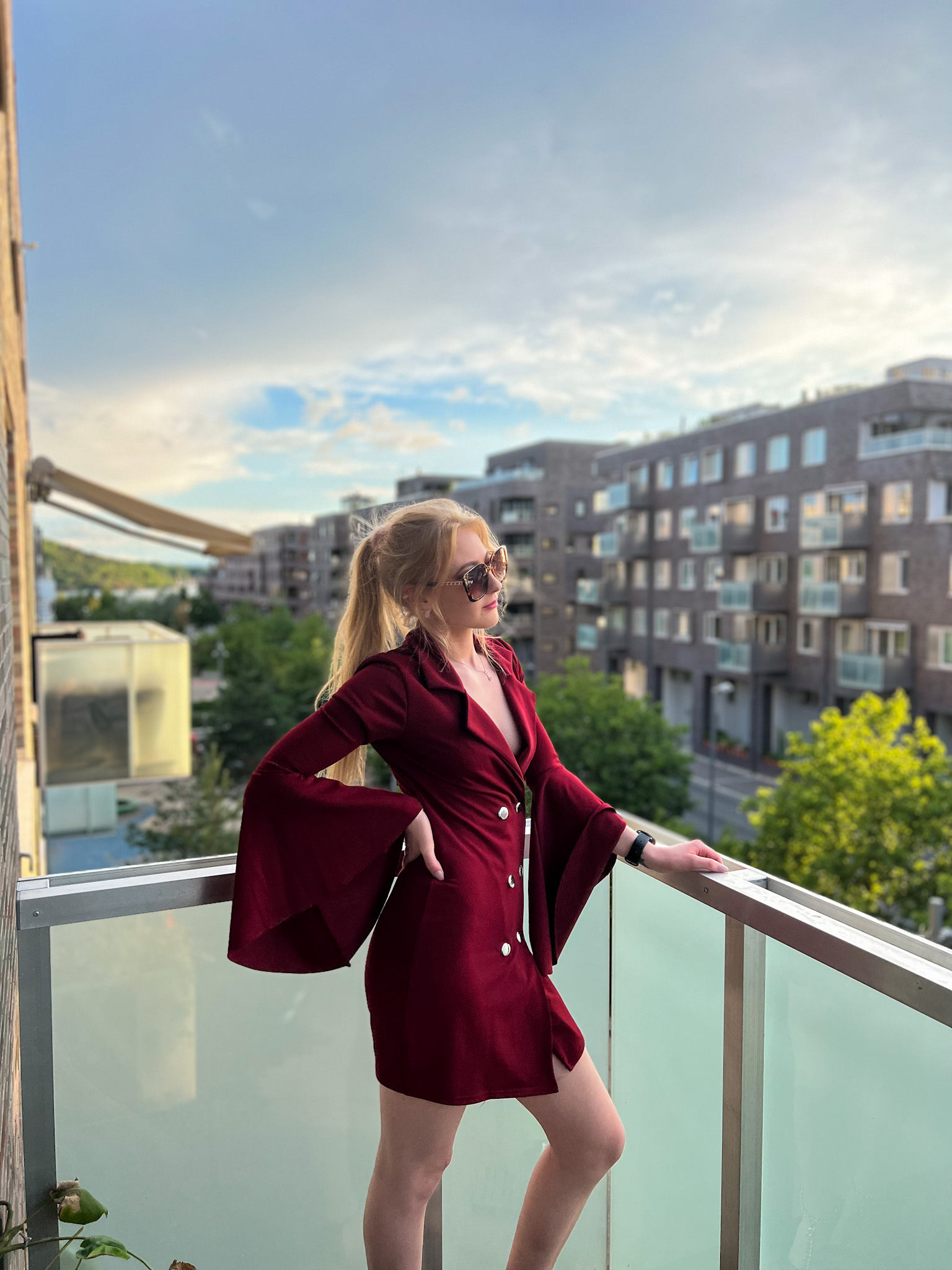 Red dress and horizon view where a woman stands watching the day be through