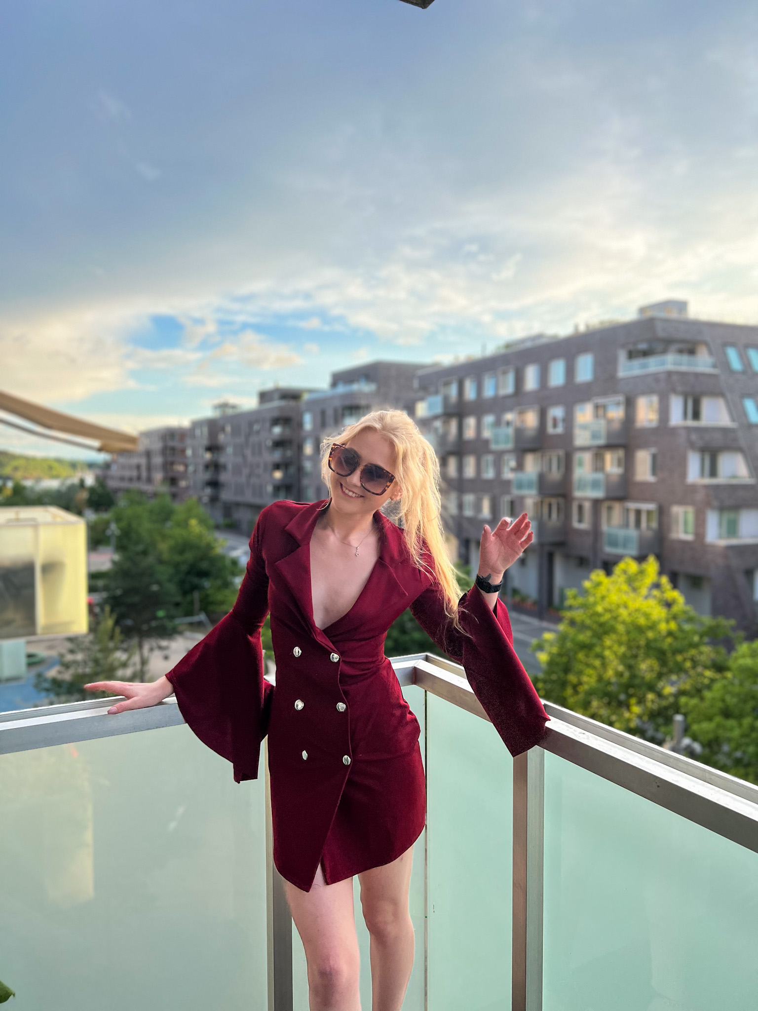 Red dress and horizon view where a woman stands watching the day be through