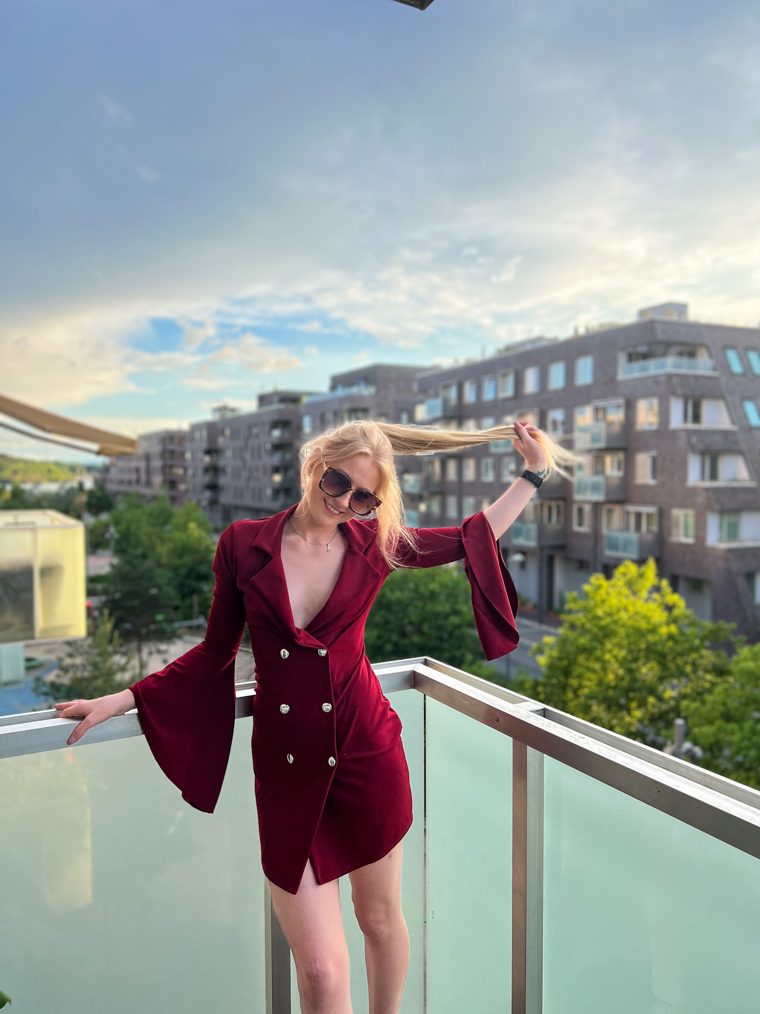 Red dress and horizon view where a woman stands watching the day be through