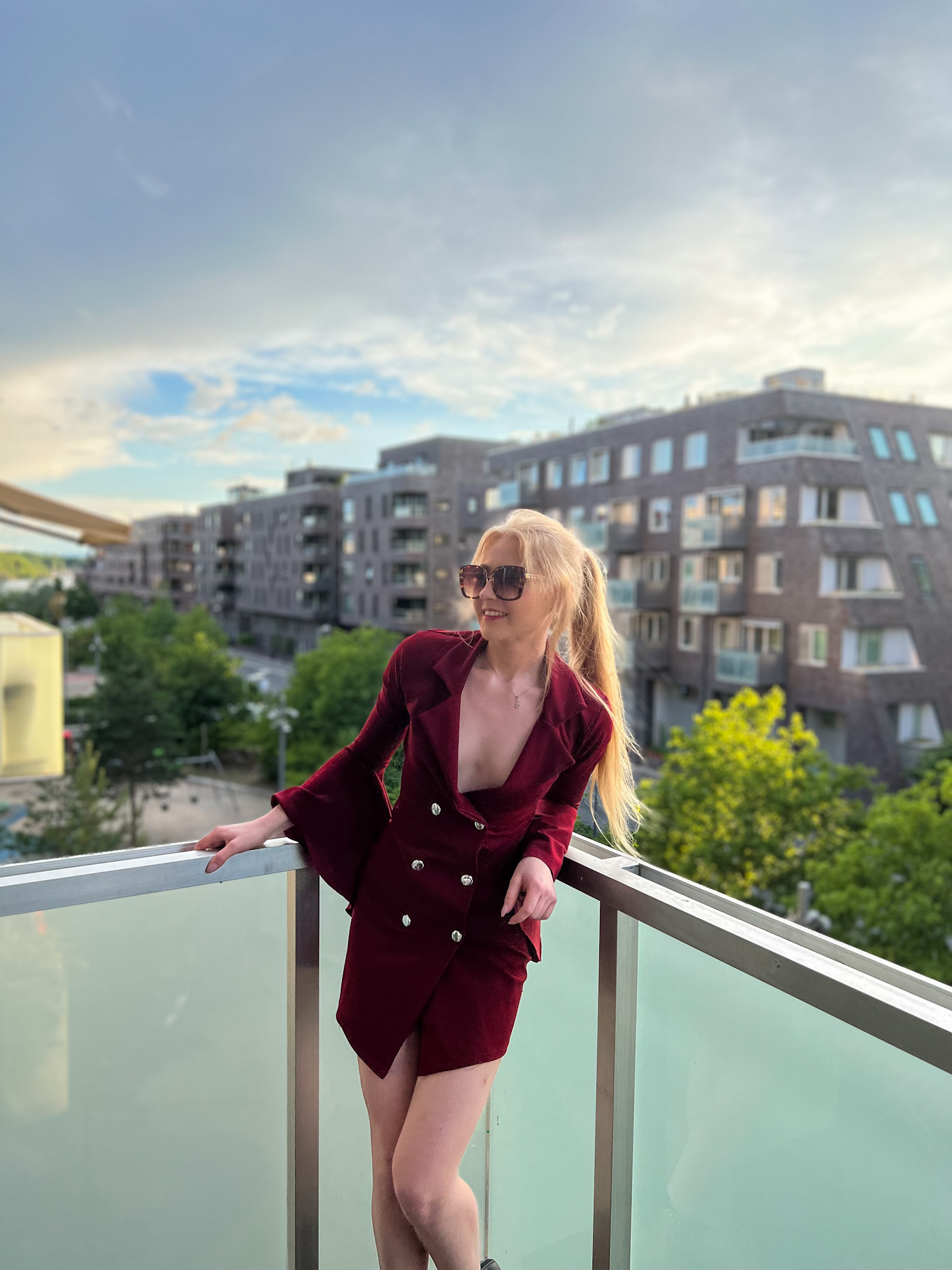 Red dress and horizon view where a woman stands watching the day be through
