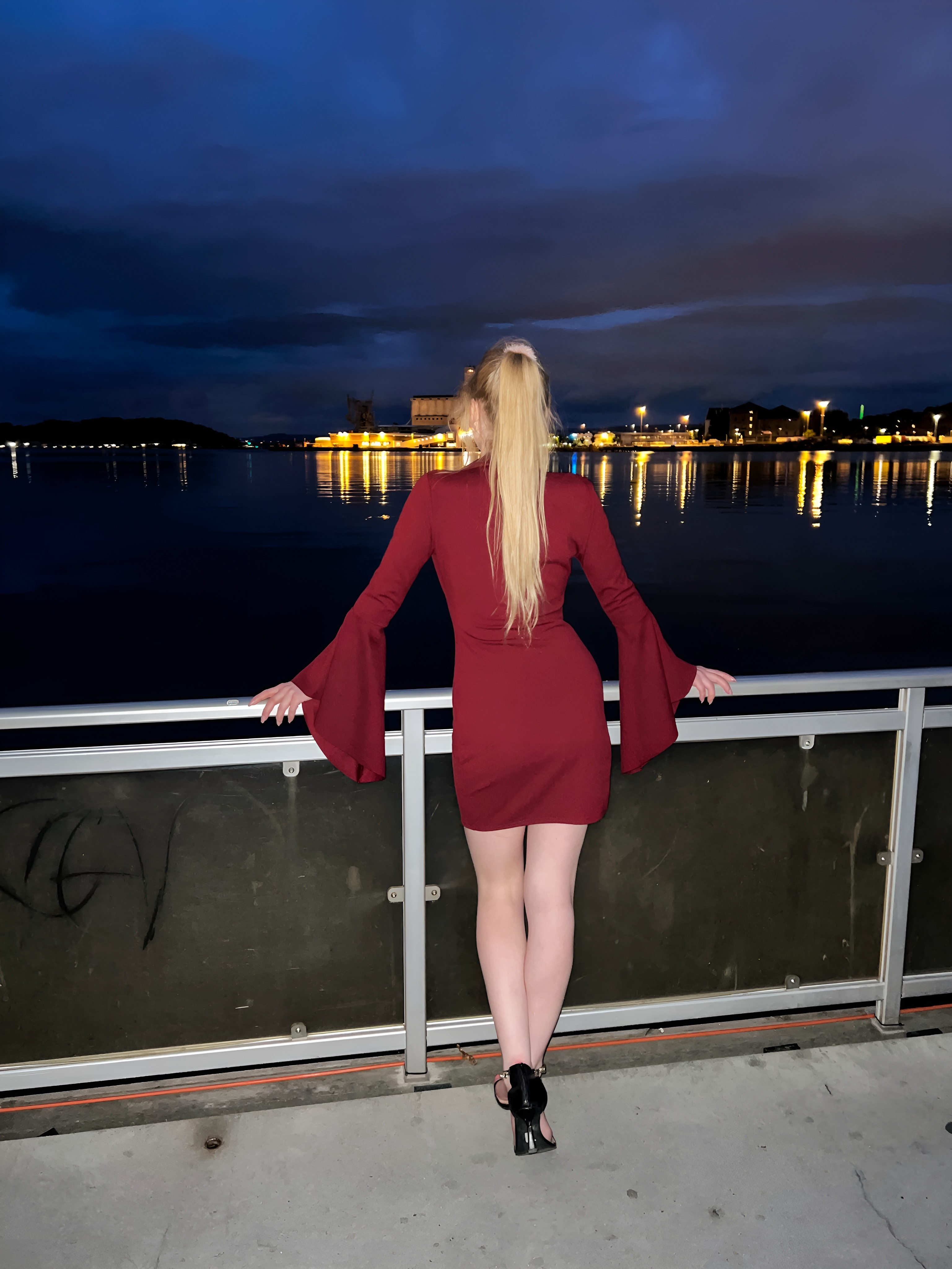 Nighttime with a view, woman in a red dress and heels
